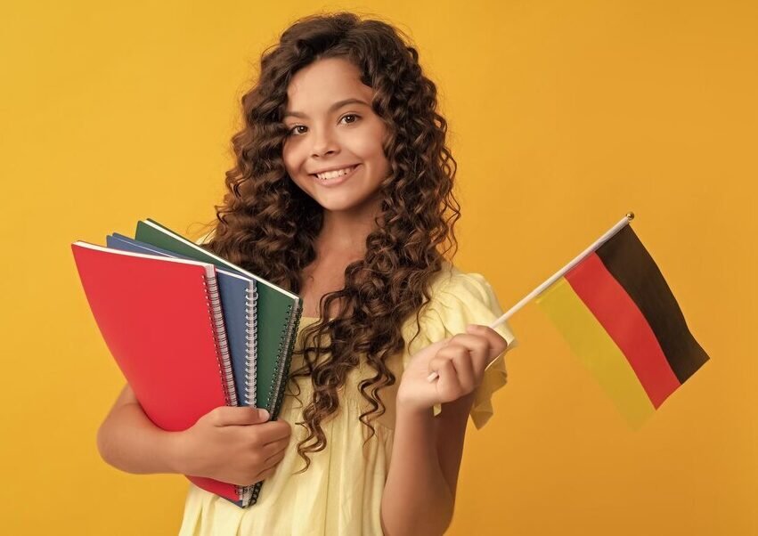 german-language-child-hold-flag-back-school-teen-girl-study-germany-portrait-schoolgirl-student-studio-banner-header-school-child-face-copyspace_545934-52424